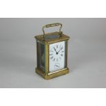 A brass cased alarm carriage clock, the white enamel dial with Roman numerals and subsidiary dial,