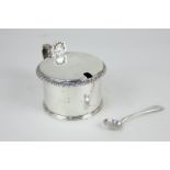 A George V silver mustard, makers Vander & Hedges (Tessiers), London 1912, with blue glass liner,