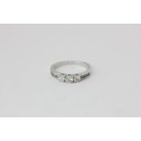 A diamond half-hoop ring claw set with three graduated brilliant cuts with three smaller stones to