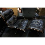 A Charles Eames rosewood lounger chair and Ottoman with black leather upholstery, without labels