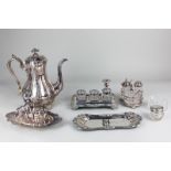 A 19th century silver plated desk stand with inkwells and taper stick, a cruet set, a toast rack,