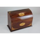 An Edwardian mahogany inlaid stationery box, the domed lid and front decorated with batwing paterae,