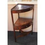 A George III mahogany corner washstand with solid top, single drawer and two dummy drawers, on