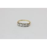 A diamond five stone ring, the graduated brilliant cuts in platinum on 18ct yellow gold