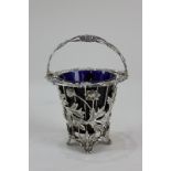 An Elizabeth II silver sugar basket of pierced floral design with blue glass liner, maker John Henry