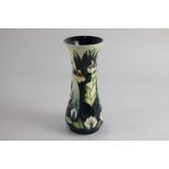 A Moorcroft pottery 'water lily' vase of waisted baluster form, decorated with plants on graduated