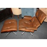 A Charles Eames rosewood lounger chair and Ottoman with brown leather upholstery, with label for