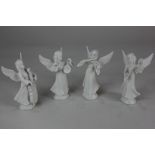 A set of four PM & M German white glazed porcelain figures of angels playing musical instruments,