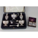 An Edward VII silver cased cruet set, makers Barker Brothers, Birmingham 1905, with two salts, two