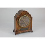 An early 20th century walnut veneered mantel clock, retailed by Russells of Manchester, in shaped