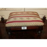 A 19th century mahogany footstool, on turned feet with pink and floral striped upholstery, 30cm