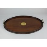 A mahogany oval butler's tray with central mother of pearl inset panel and two brass handles, 55cm