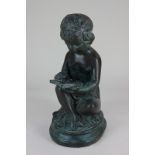 A modern bronzed metal model of a putto reading a book, label verso for Maitland-Smith Ltd, 36cm