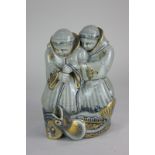 A Royal Copenhagen porcelain figure group of two monks pulling a fish on a line, with gilt