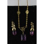 An amethyst pendant on an oval link chain, with a pair of similar drop earrings