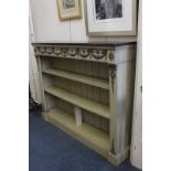 A painted bookcase, the rectangular mahogany top with fluted edge, with a metal mounted frieze of