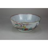 A Chinese porcelain bowl decorated with figures on a terrace and beside a coastline, 23cm