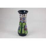 A Moorcroft pottery 'Violet' vase with floral stained glass effect decoration in purple, pink and