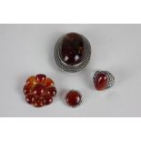 A silver mounted amber brooch, and three items of brown hardstone jewellery (amber not tested)