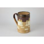 A Doulton Lambeth silver mounted stoneware tankard decorated in raised relief with countryside