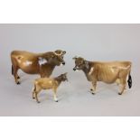 A Beswick Jersey cow model group comprising bull, Ch Dunsley Coy Boy, 12cm, (a/f), cow, Ch Newton