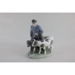 A Royal Copenhagen porcelain figure group of a cow herder with two cows, model 1858, 23cm high