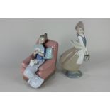 A Nao porcelain figure of a girl seated on a pink armchair holding a fan, 19.5cm, and another of a