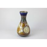 A Doulton Lambeth stoneware vase of pear shaped form with fluted neck, in the Chinese manner with