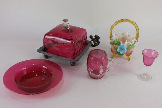 A small collection of cranberry glass to include a mug painted with a figure dressed in white and