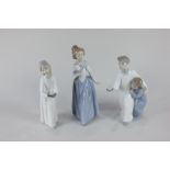 Two Lladro porcelain figures of children in night dresses with candles, and a Nao porcelain figure