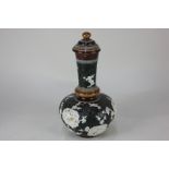 A Doulton Lambeth Slaters bottle vase and cover decorated in white with medallions of birds and