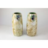 A pair of Royal Doulton stoneware vases of cylindrical form with tubeline floral decoration on a