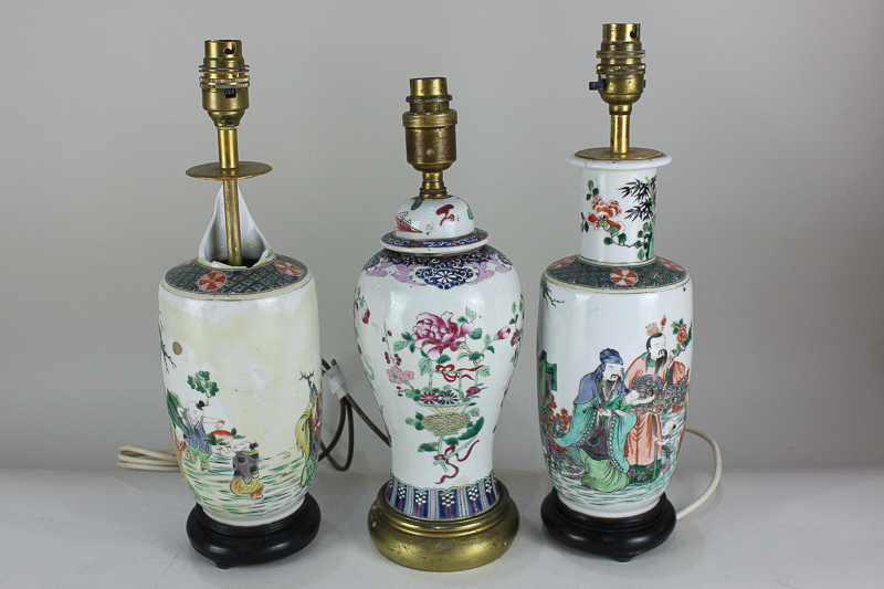 Three Chinese porcelain baluster vase table lamps including a pair depicting figures, on hardwood