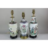 Three Chinese porcelain baluster vase table lamps including a pair depicting figures, on hardwood
