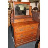 An Edwardian dressing chest with adjustable mirror, shelf and jewellery drawers, above three long