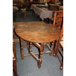 An 18th century oak oval gateleg table with two drop flaps and end drawer, on turned and block