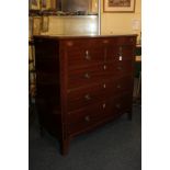 A George III mahogany flat front chest of two short over three long drawers, the frieze inlaid