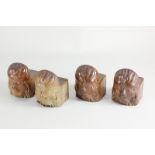 A set of four glazed pottery mask fronted furniture or pot stands, 5.7cm