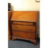 A George III mahogany bureau with writing fall front enclosing fitted interior, above three drawers,