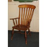 A farmhouse kitchen chair with curved slatted back and scroll arms, on turned supports and legs