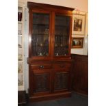 A Victorian style glazed bookcase, the top section with two glazed panel doors enclosing three