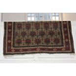 A Persian wool rug with floral design in blue and red on cream ground 154cm by 228cm