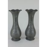 A pair of Kayserzinn pewter vases of slender baluster form with fluted neck, decorated with flowers,