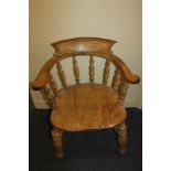 A pine bow-back elbow chair with baluster supports, solid seat, on turned legs