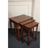 A nest of three oak rectangular side tables on turned supports with low stretchers, largest 45cm