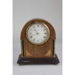An Edwardian inlaid mahogany mantle clock, the circular dial marked Sir John Bennett Ltd, of domed