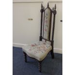 A Victorian tapestry seated nursing chair, the upholstered panel back with bobbin turned supports