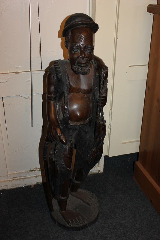 An African hardwood carved statue of a fisherman, 90cm high