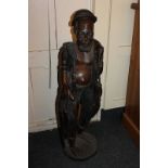 An African hardwood carved statue of a fisherman, 90cm high