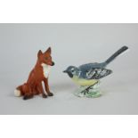 A Beswick porcelain model of a grey wagtail, 7cm, and another of a seated fox, 7cm